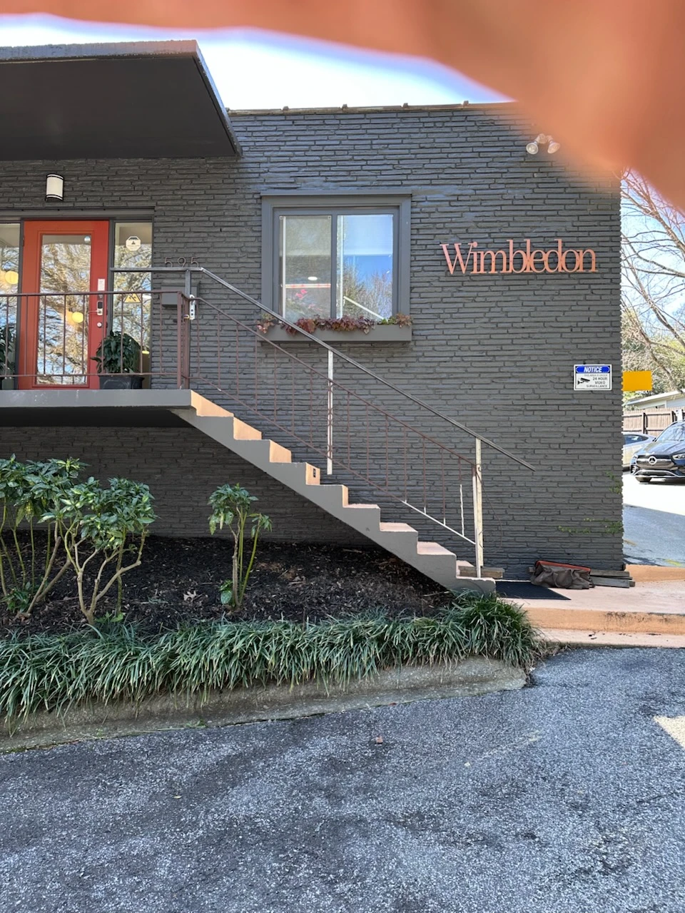 Apartment building entrance with worn thin metal railings on the exterior stairs before replacement