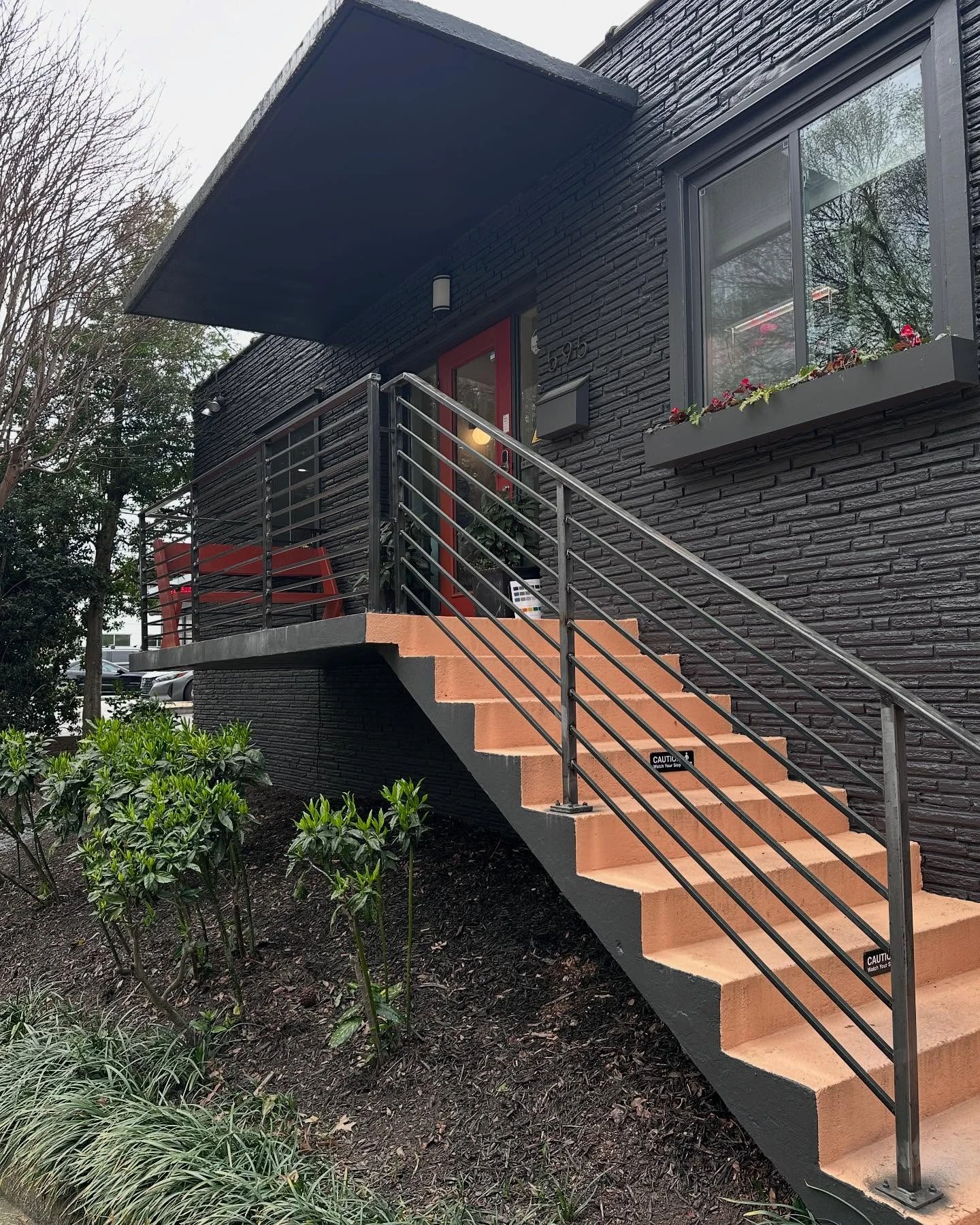 New modern horizontal bar steel railings on the exterior entry stairs of the Wimbledon building